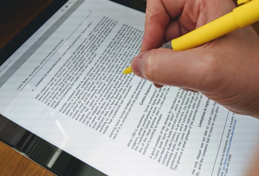 Photograph of physical highlighter over a tablet screen.